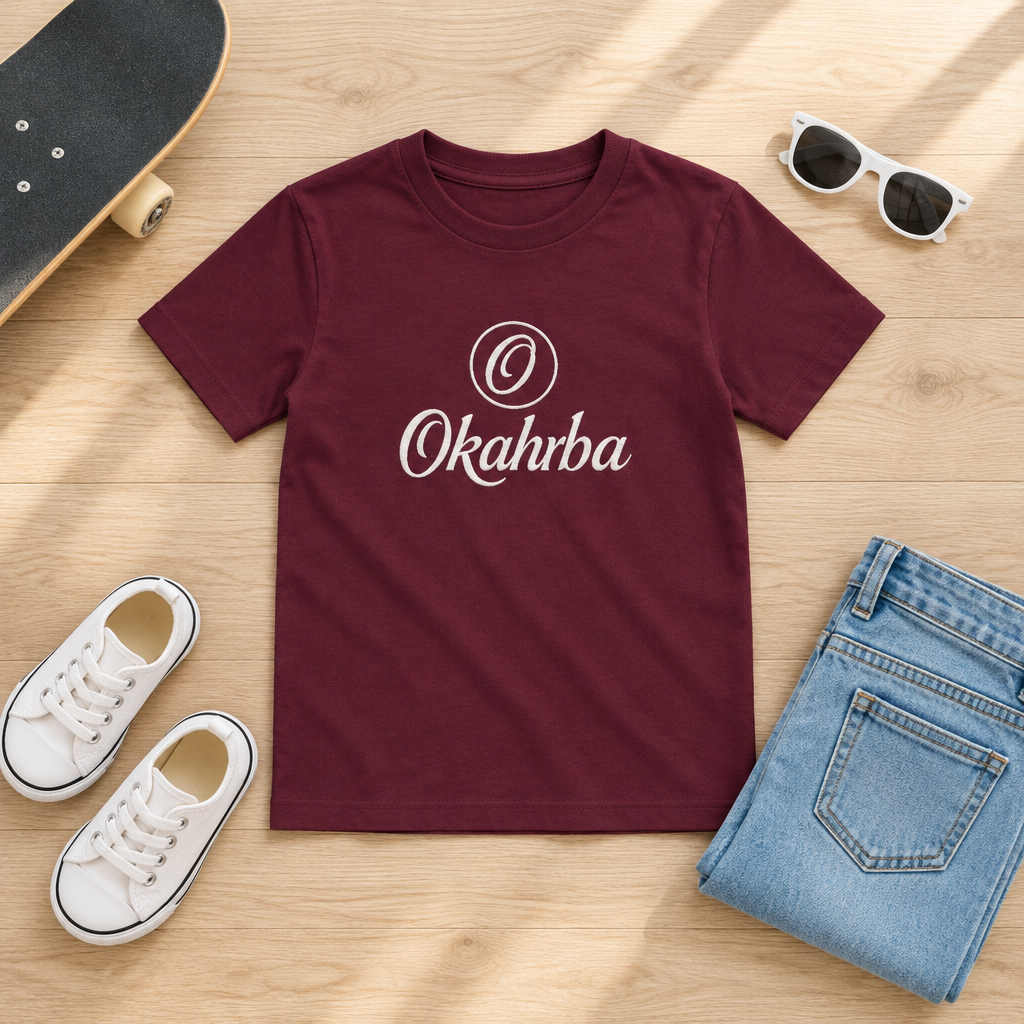 Okahrba Youth Signature Tee in maroon, styled flat lay